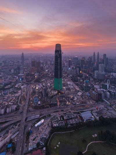 High angle view of modern buildings against sky during sunset