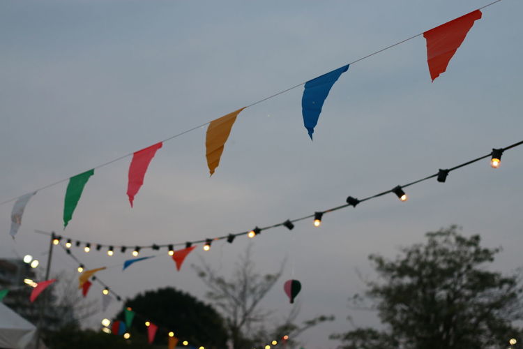 Low angle view of flags against sky at dusk