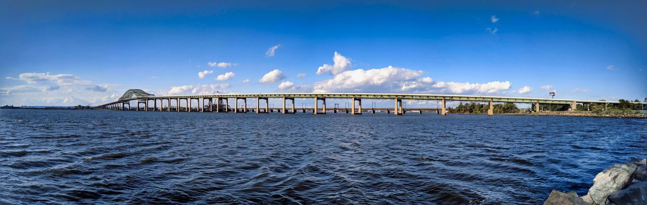 Bridge over sea against blue sky