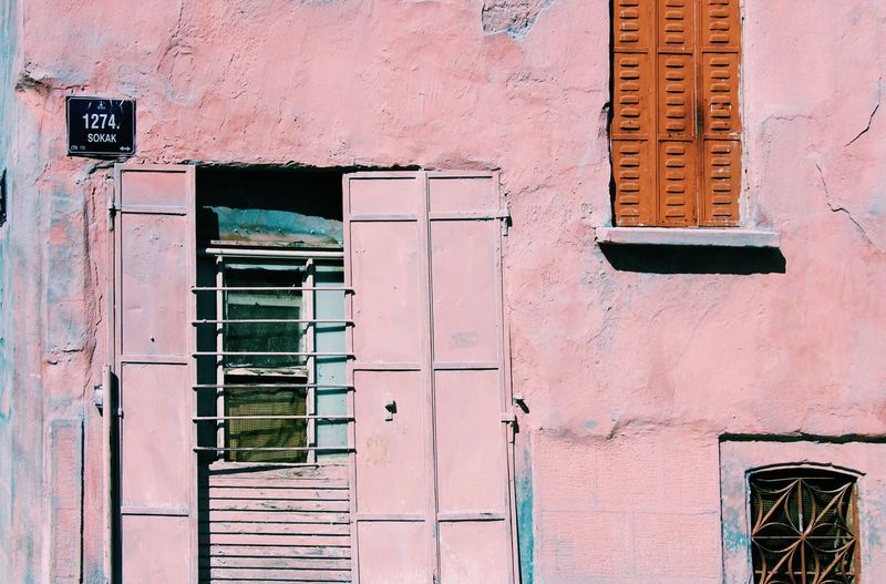 Low angle view of window on building pink