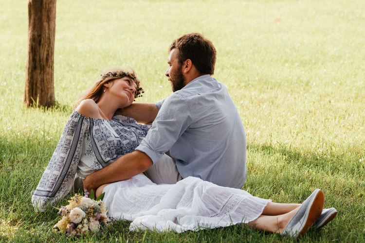 Couple sitting on grass outdoors
