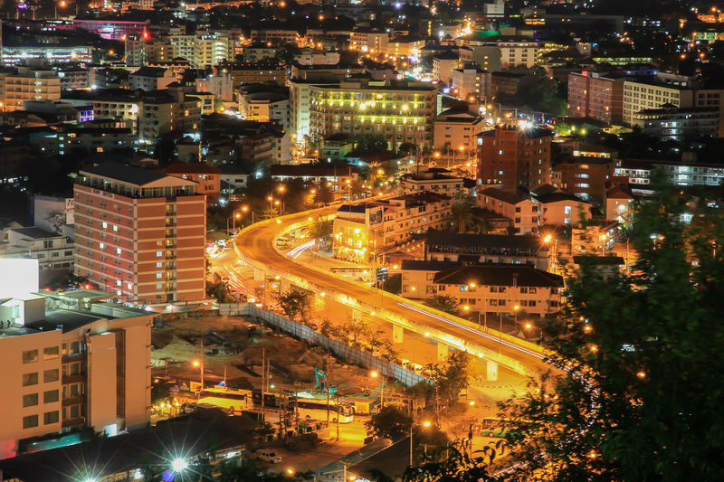 High angle view of illuminated street amidst buildings at night