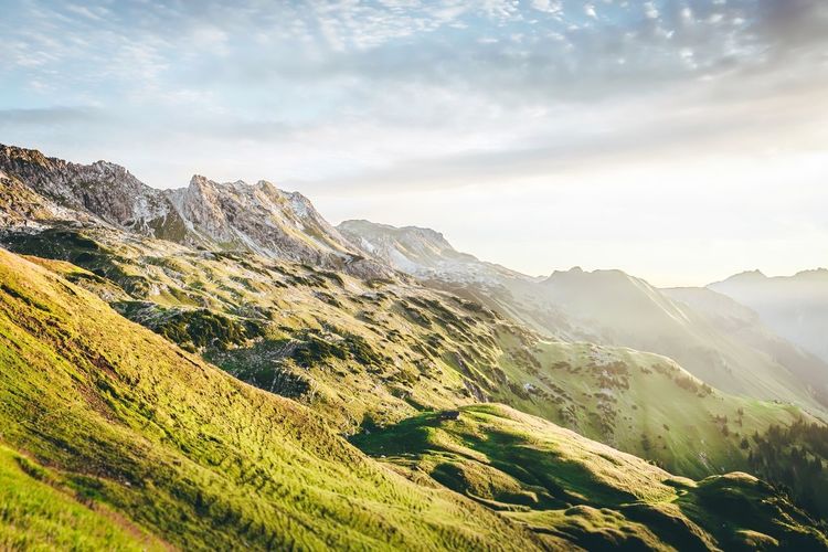 Scenic view of mountains against cloudy sky