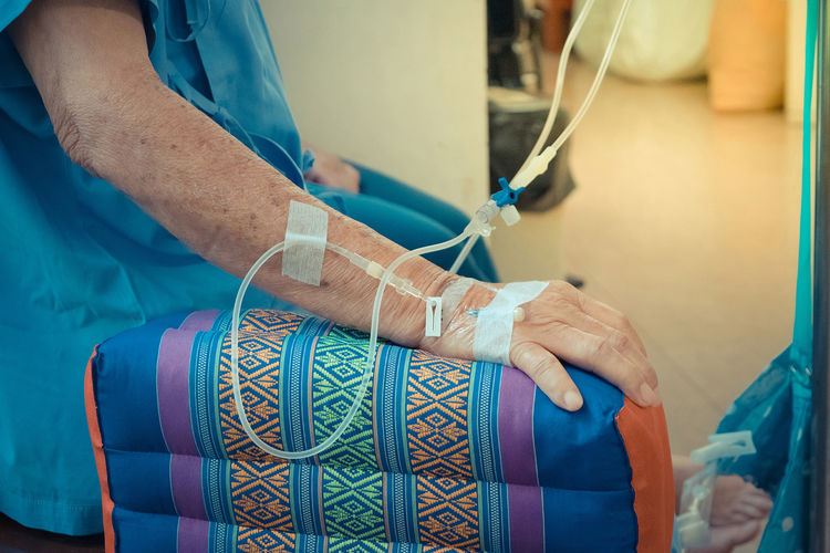 Midsection of female patient with iv drip