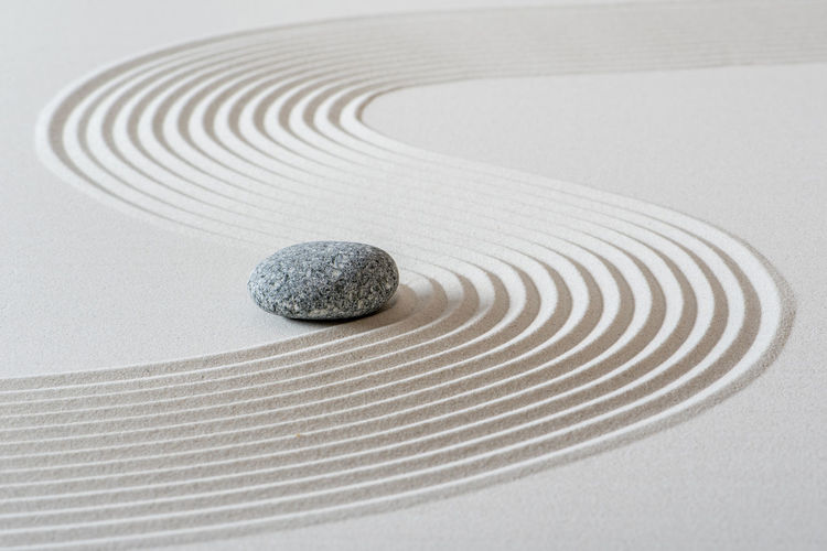 Japanese zen garden with stone in sand