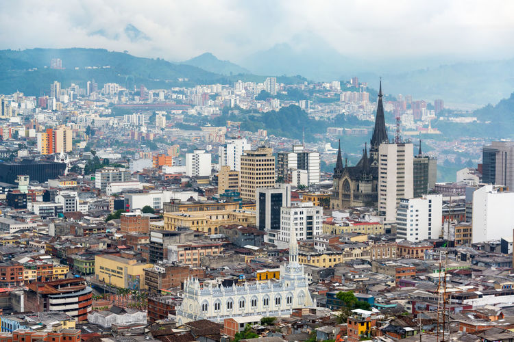 High angle view of cityscape against cloudy sky