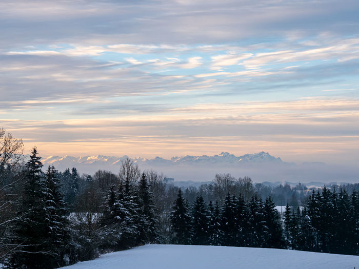 Scenic view of snowcapped mountains against sky during winter