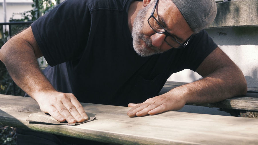 Man finishing furniture at workshop