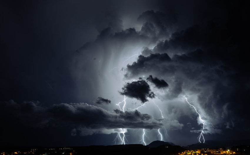 Lightning storm over the city at night
