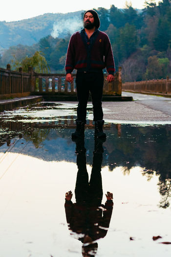 Full length of man standing on lake against sky