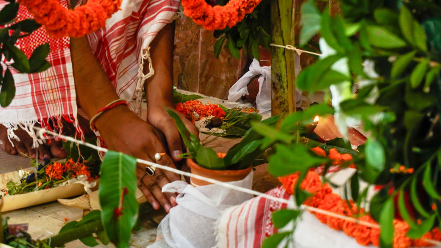 Low section of man praying during puja