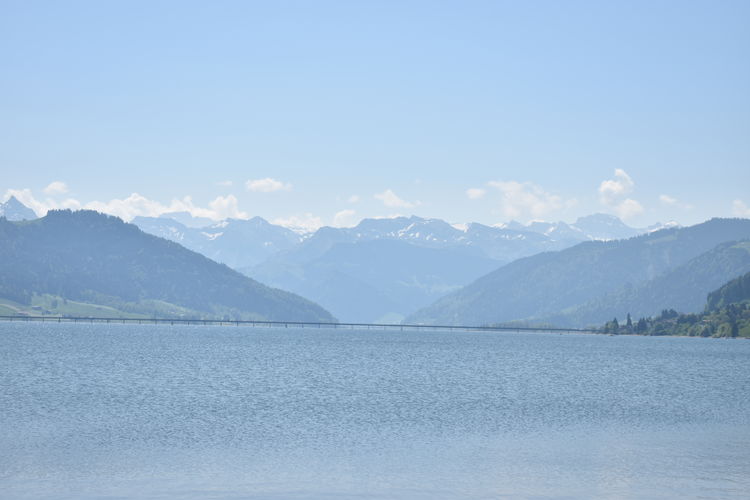 Scenic view of lake and mountains against sky