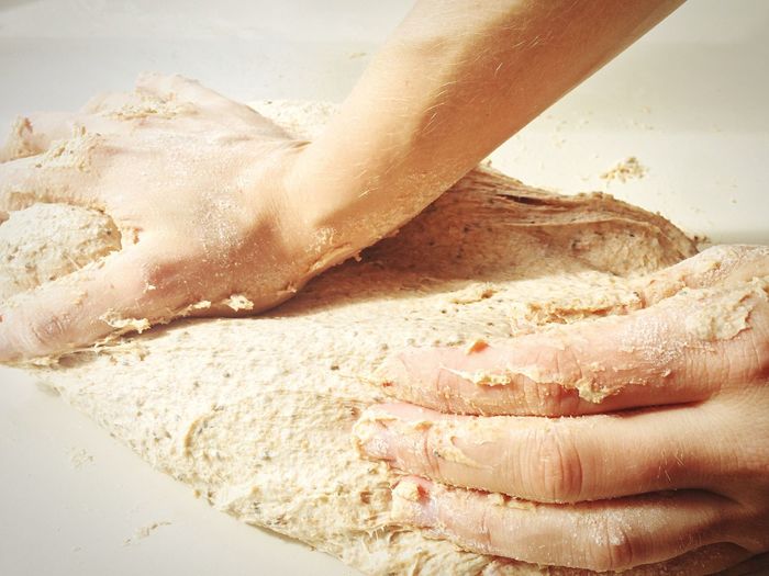 Cropped image of person kneading dough