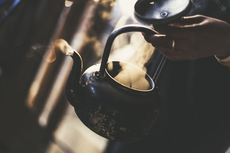 Close-up of hand holding kettle
