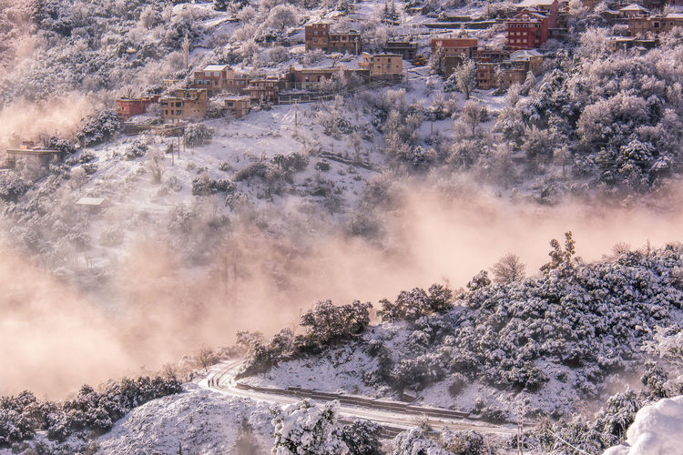 Scenic view of snowcapped landscape in foggy weather