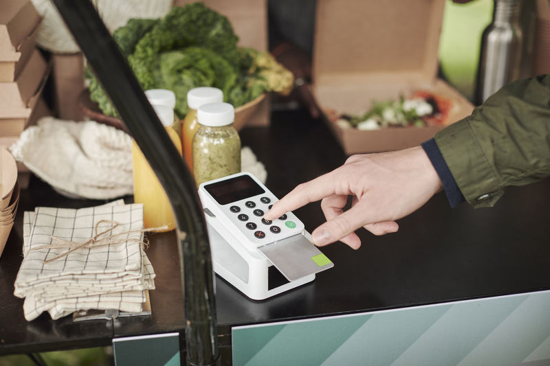 Close-up of person using card reader