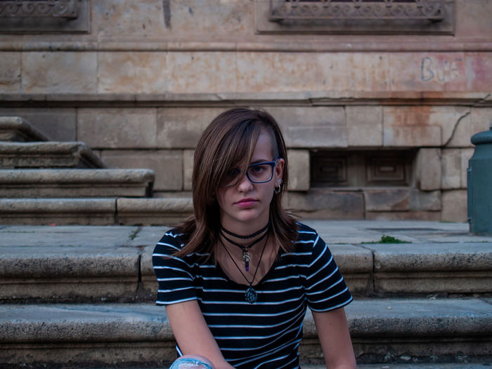 Portrait of teenage girl sitting on steps