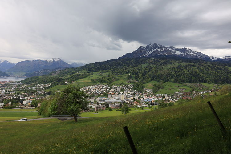 Scenic view of townscape and mountains against sky. switzerland
