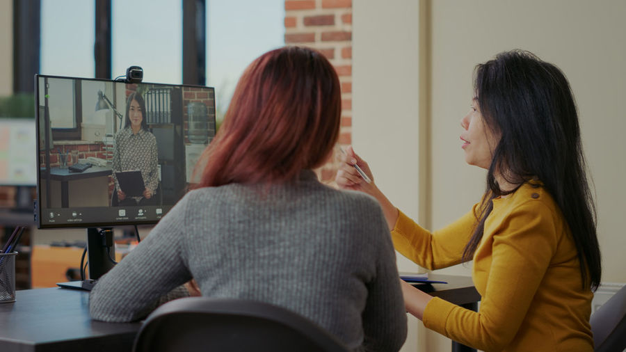Businesswomen doing video call on desktop pc
