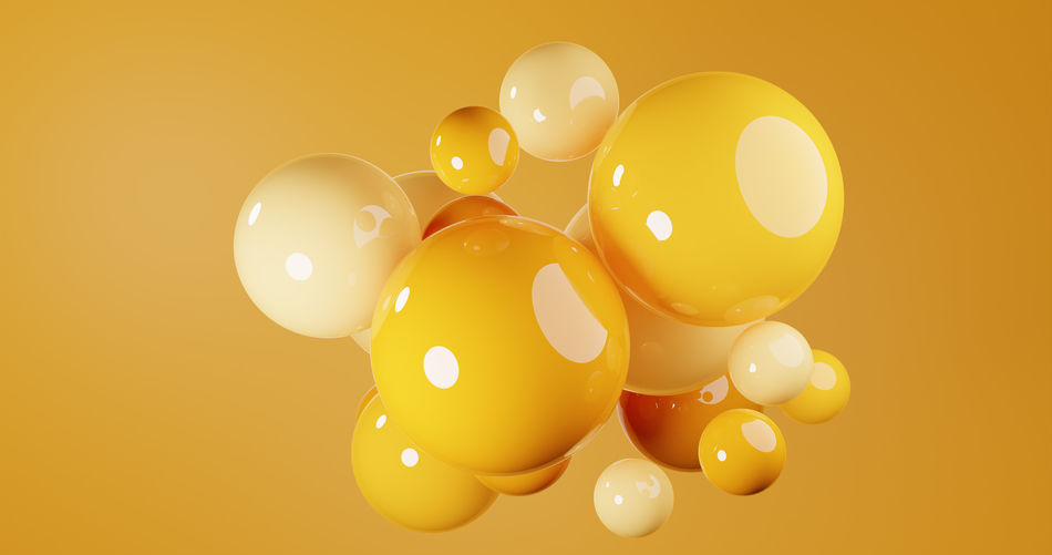 Close-up of balloons against yellow background
