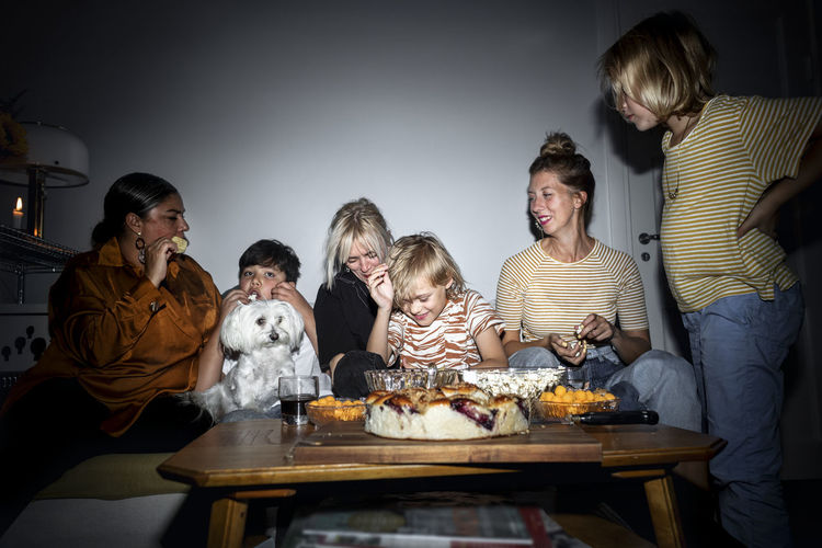 Family with kids snacking in living room