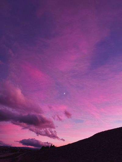LOW ANGLE VIEW OF DRAMATIC SKY OVER SILHOUETTE MOUNTAIN