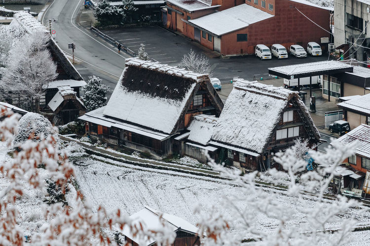 High angle view of snow covered houses by building