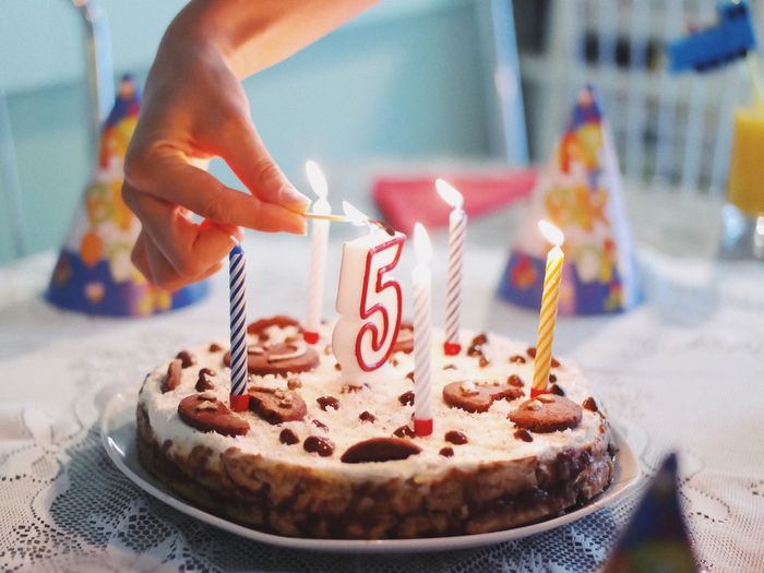 Close-up of hand holding ice cream on table