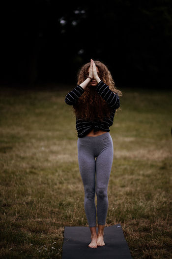 Rear view of woman standing on field