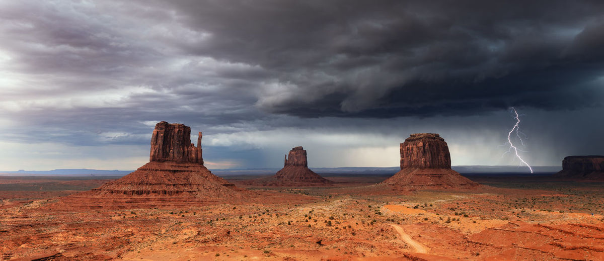 A thunderstorm with dramatic clouds and lightning sweeps through monument valley, arizona