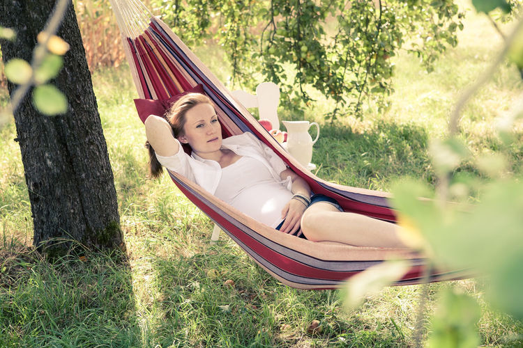 High angle view of woman sitting on hammock