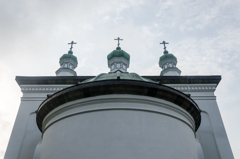 Low angle view of building against cloudy sky