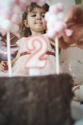 A 2 year old girl celebrating her birthday