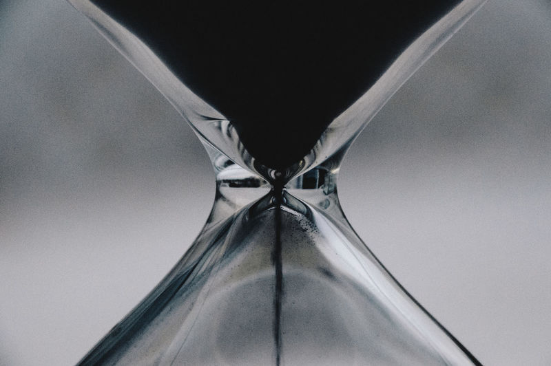 Close-up of hourglass against black background