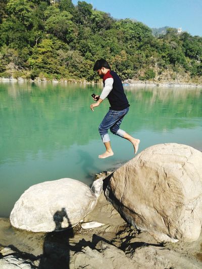 Man jumping over lake