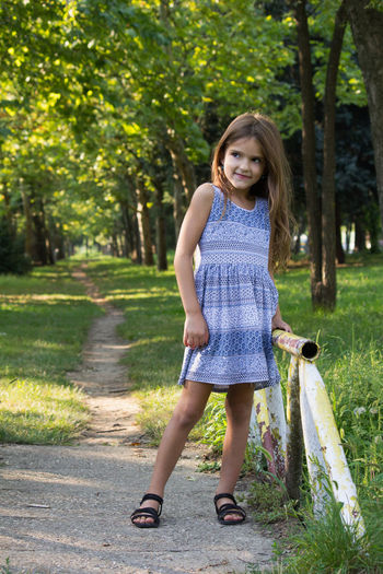 Portrait of smiling girl wearing hat looking away at park