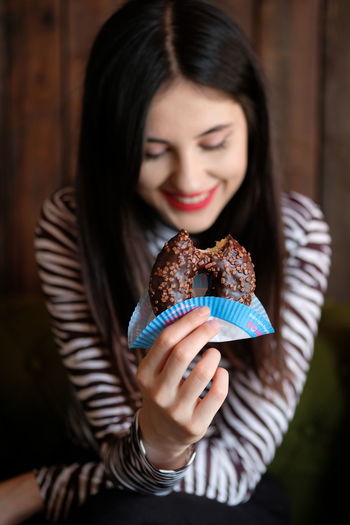 High angle view of woman eating donut