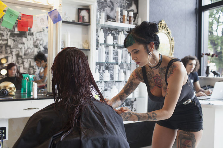A hairdresser styling a customer's hair. 