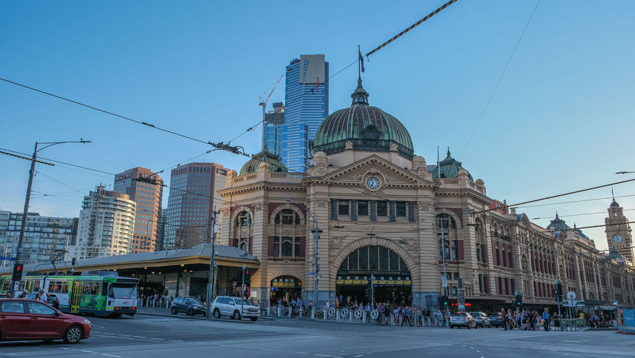 Buildings in city against clear sky