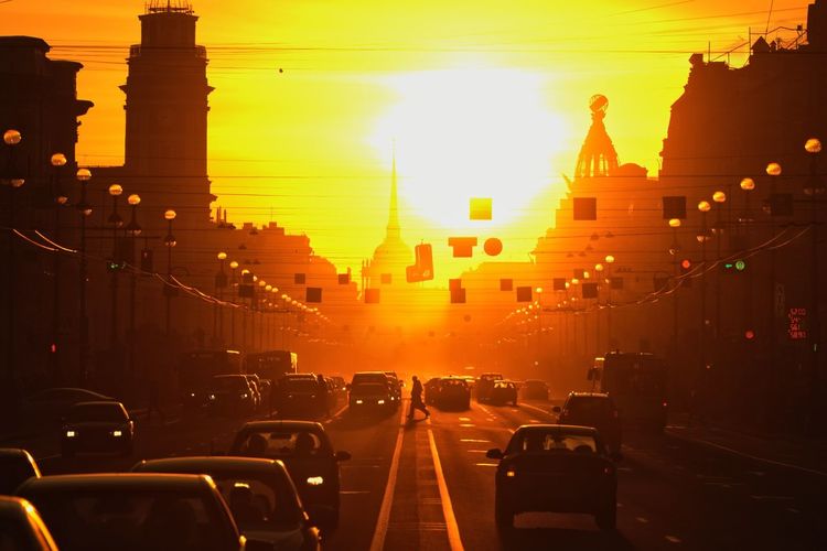 Traffic on road at sunset