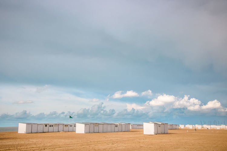 Scenic view of beach huts against sky