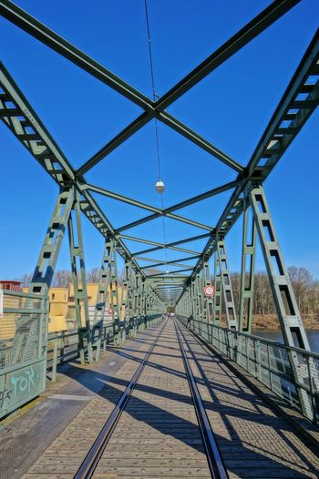 Railway bridge against clear blue sky