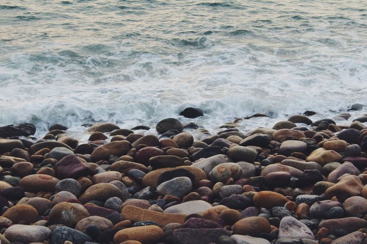 High angle view of pebbles at beach