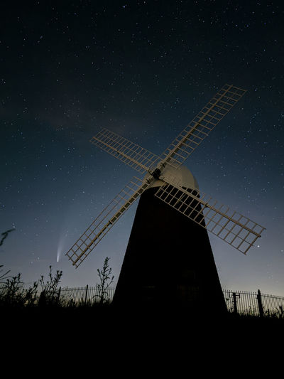 Low angle view of windmill against sky at night