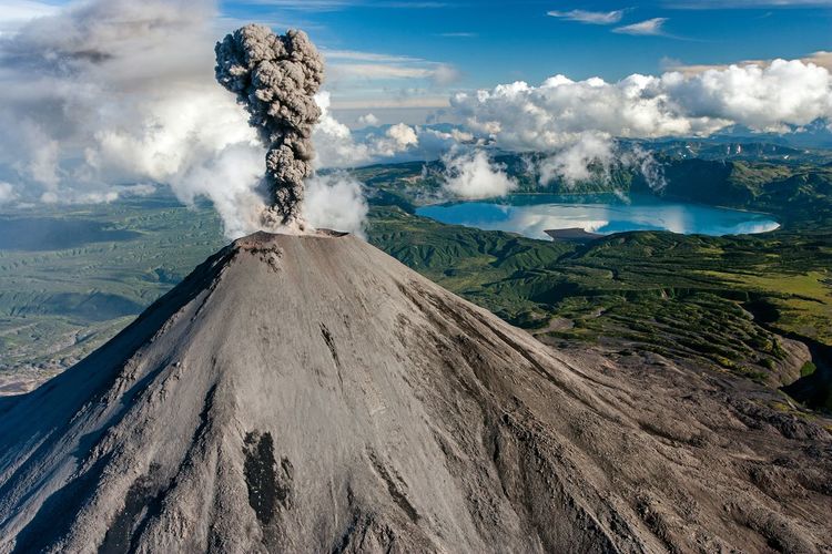 View of karymsky volcano erupting against sky