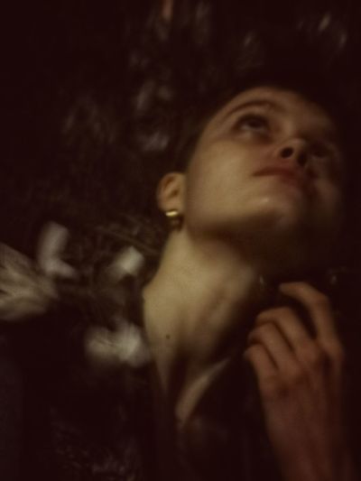 Close-up portrait of a young woman looking up