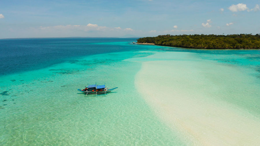 Seascape with a beautiful beach and tropical island. mansalangan sandbar.  balabac, palawan