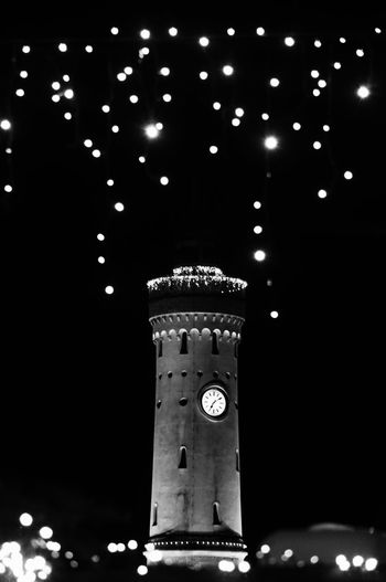 Low angle view of illuminated tower at night