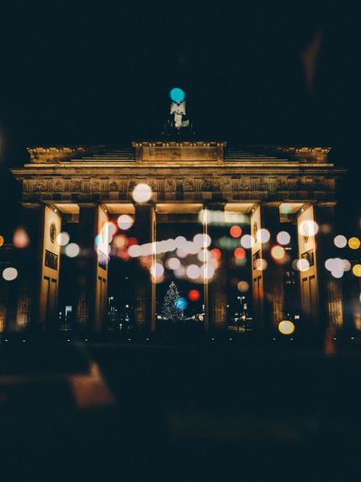Low angle view of brandenburg gate against sky at night