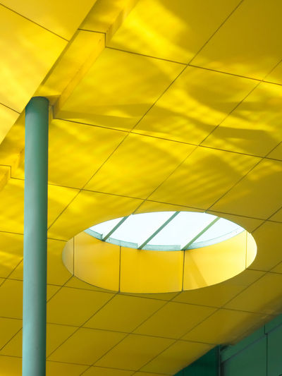 LOW ANGLE VIEW OF YELLOW LIGHTS ON CEILING